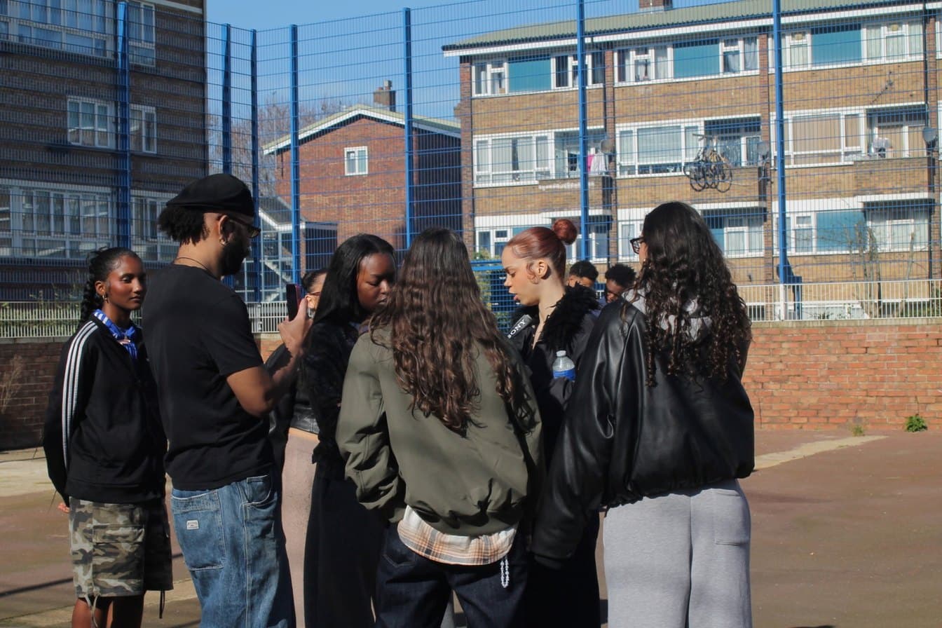 The Gyaldem FC crew huddled on a London estate pitch
